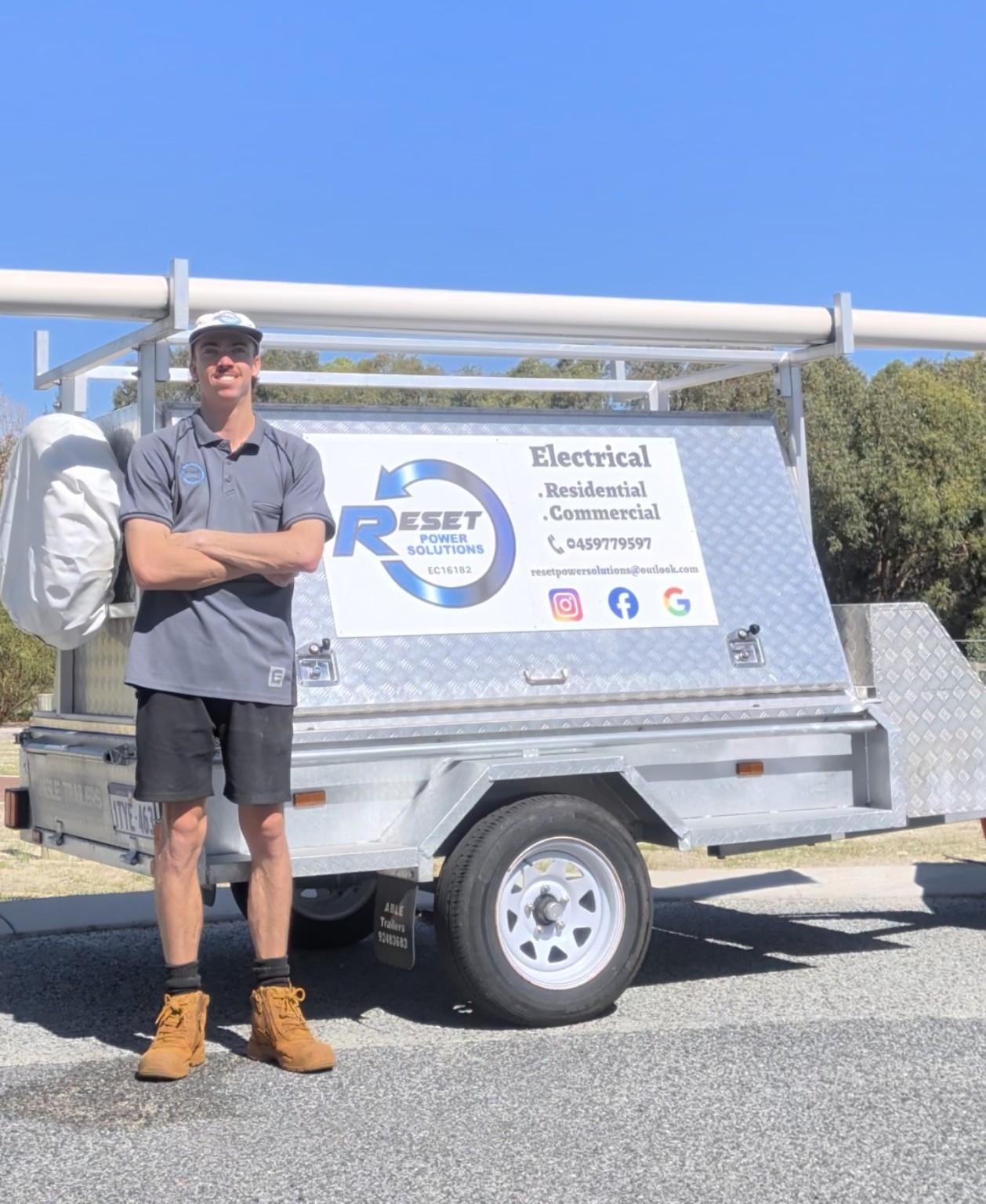 Brodie from Reset Power Solutions beside work trailer